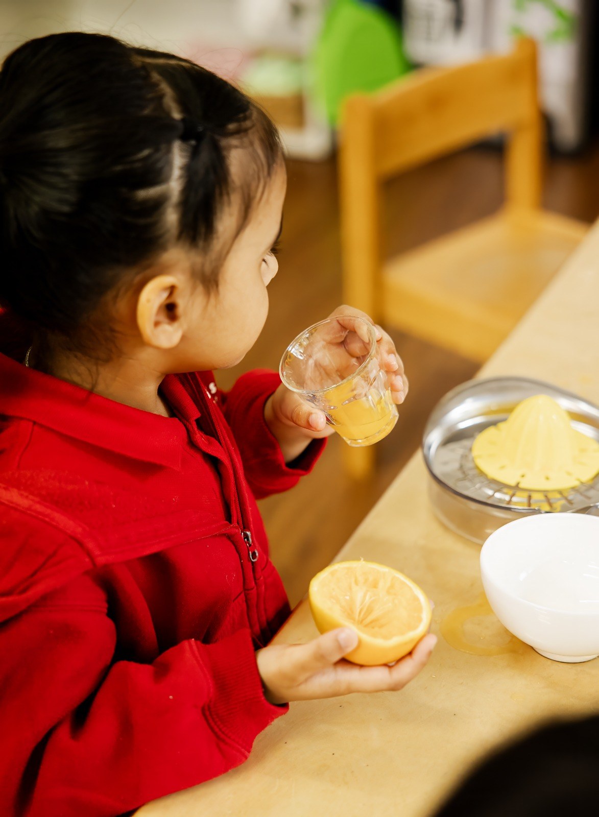A child squeezing lemon juice as a practical life activity