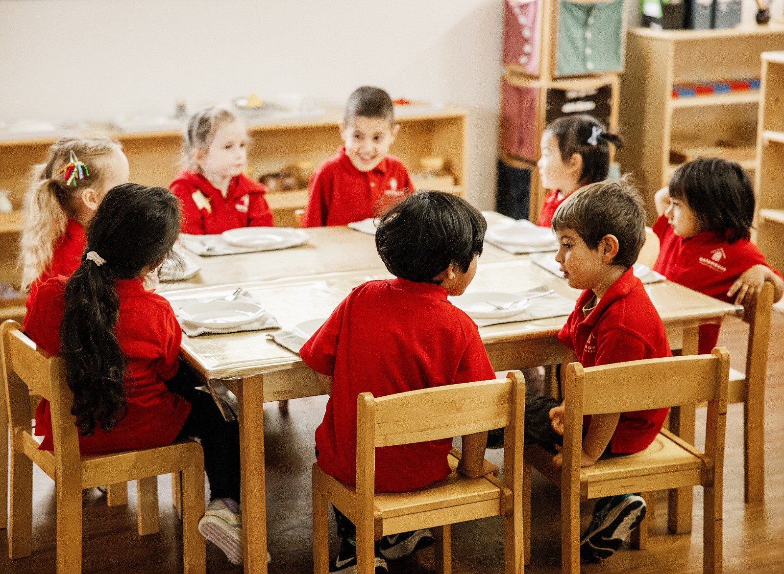 Children seated together at a low table during mealtime