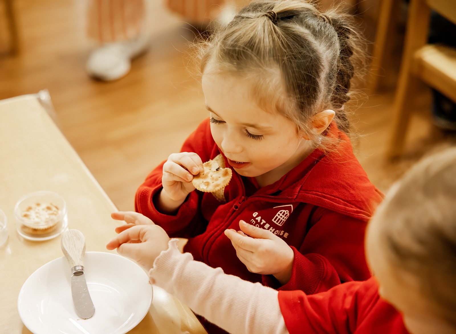 A child enjoying a snack at the table