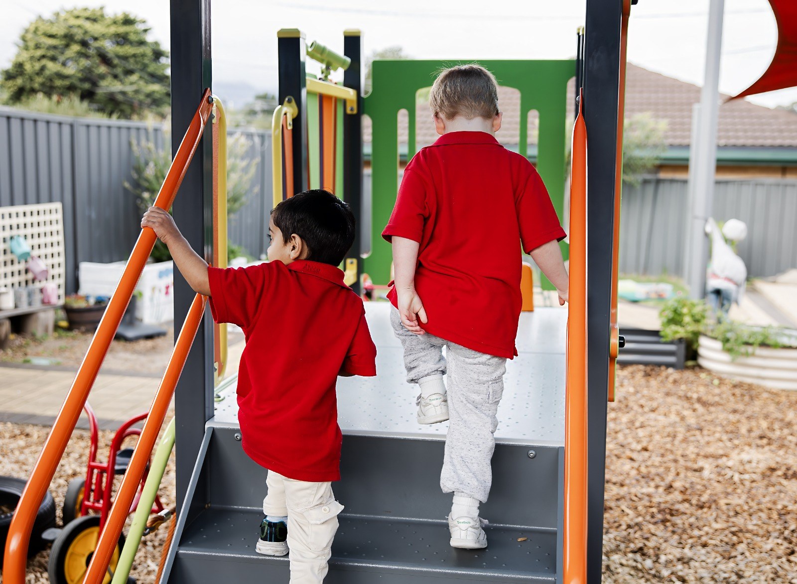 Children climbing on outdoor playground equipment