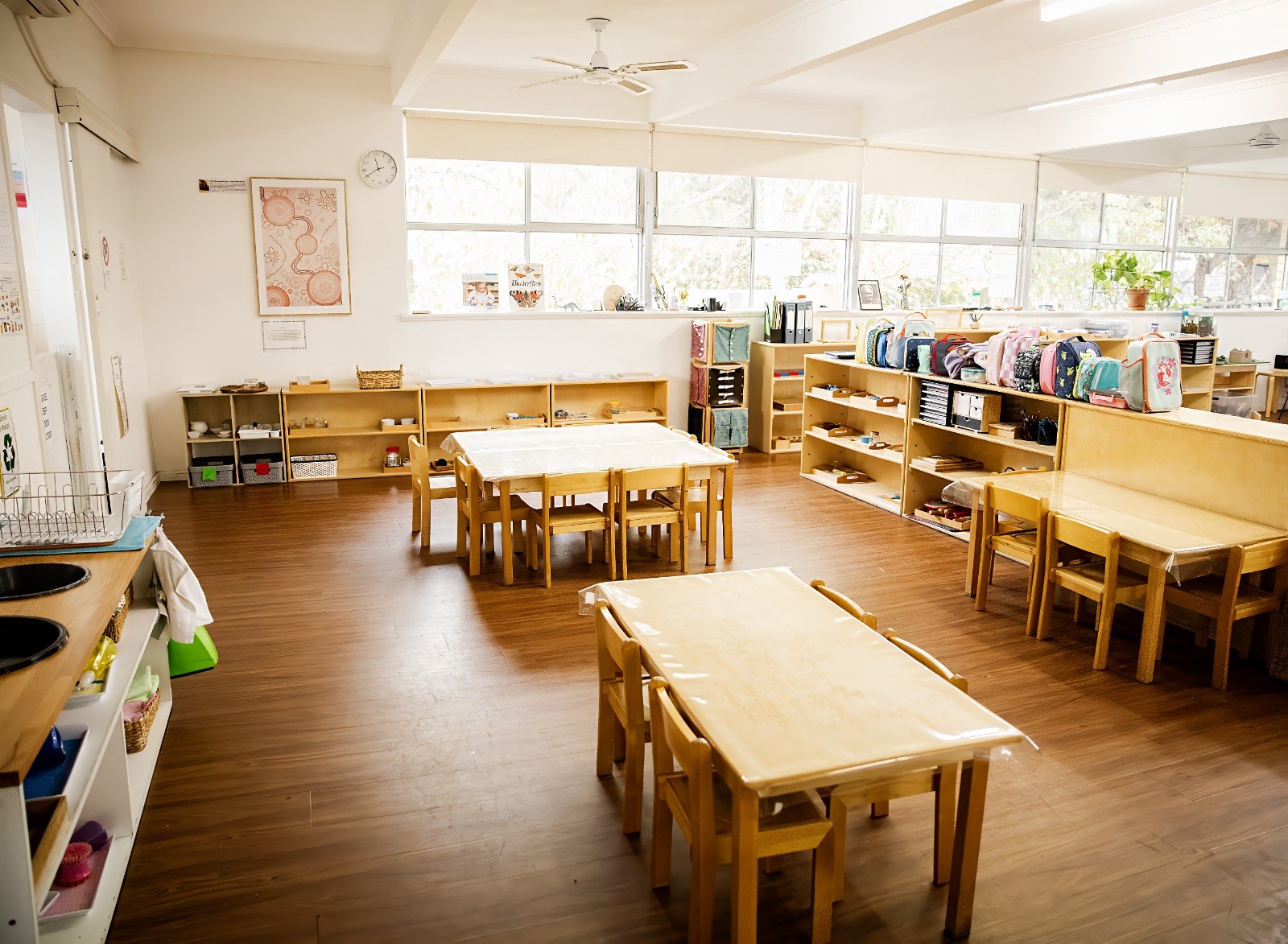 A wide view of classroom tables and chairs set up for work