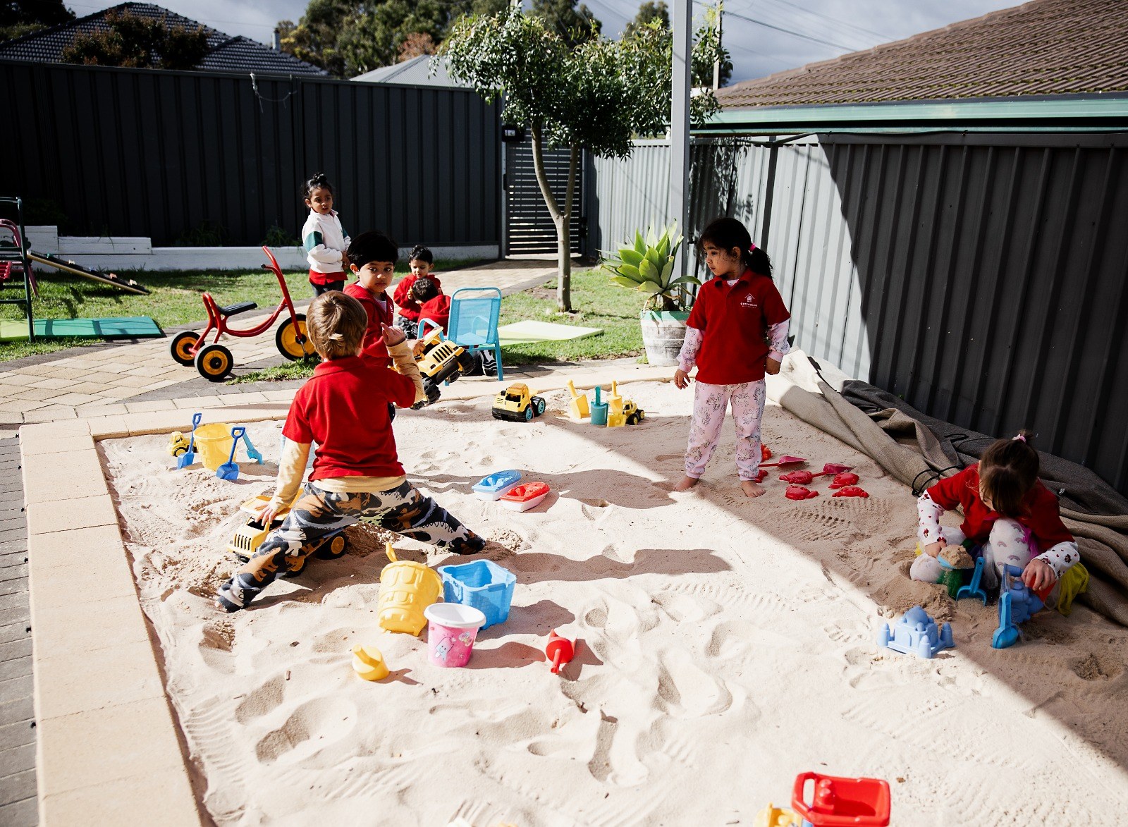 Children playing in the outdoor sandpit and play area