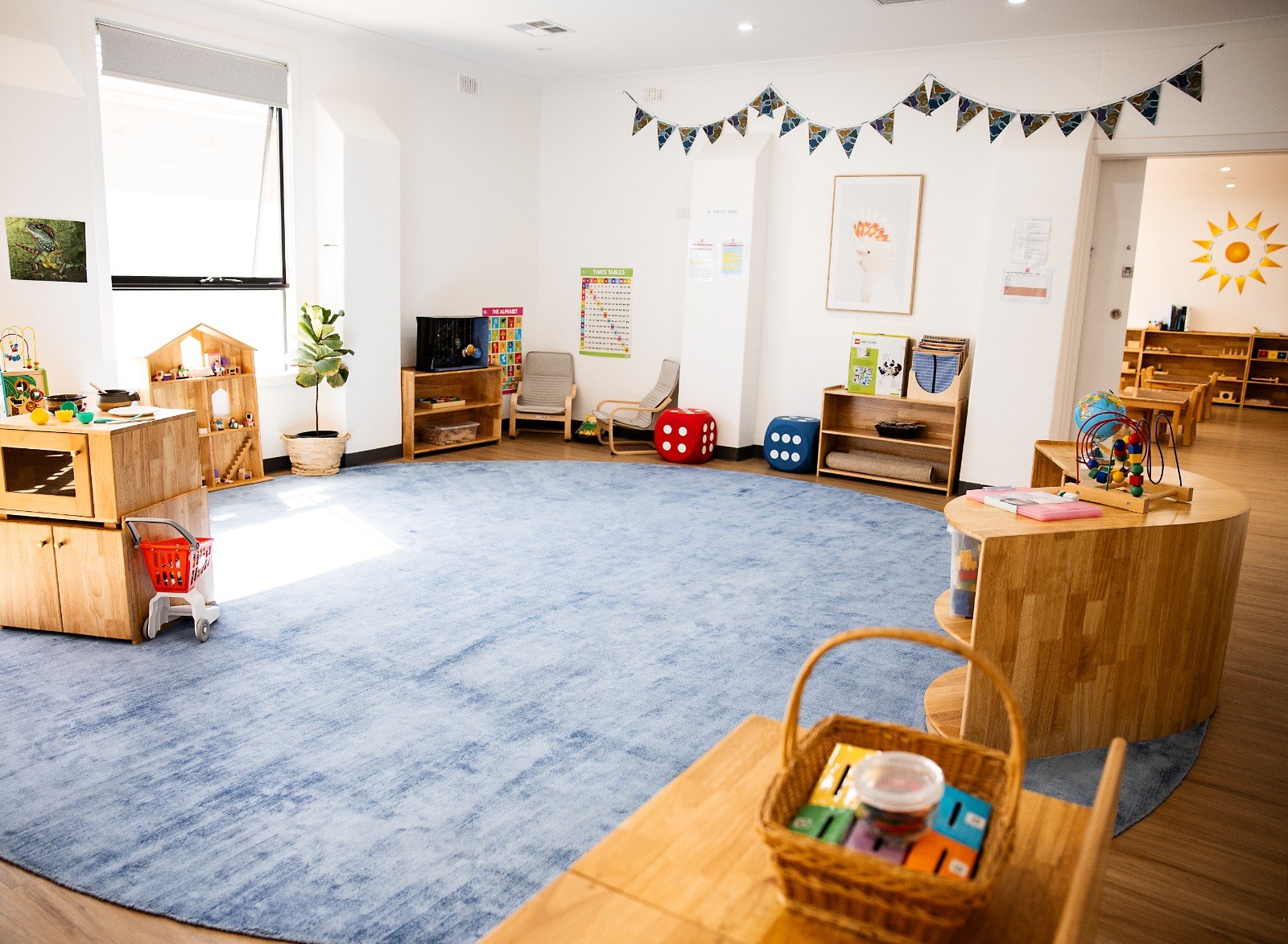 A wide view of a classroom space with flags on display