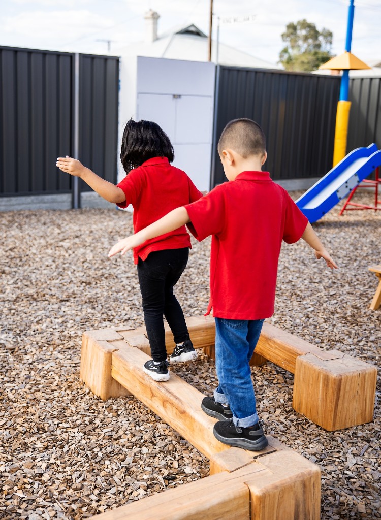 Children walking the outdoor balance beams at Rosewater