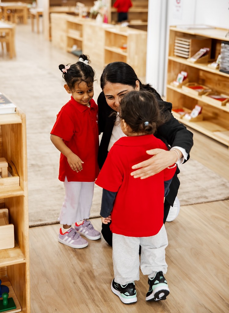 An educator greeting children in the Rosewater classroom