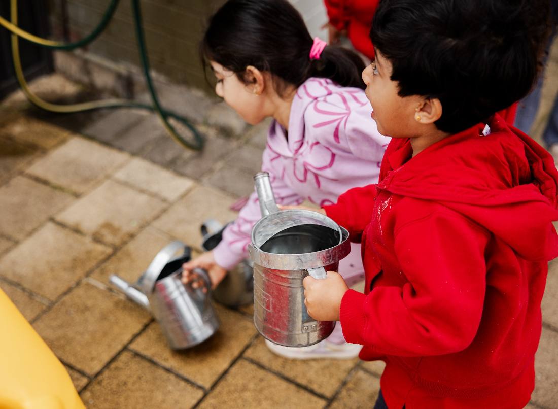Children exploring independently in the sandpit