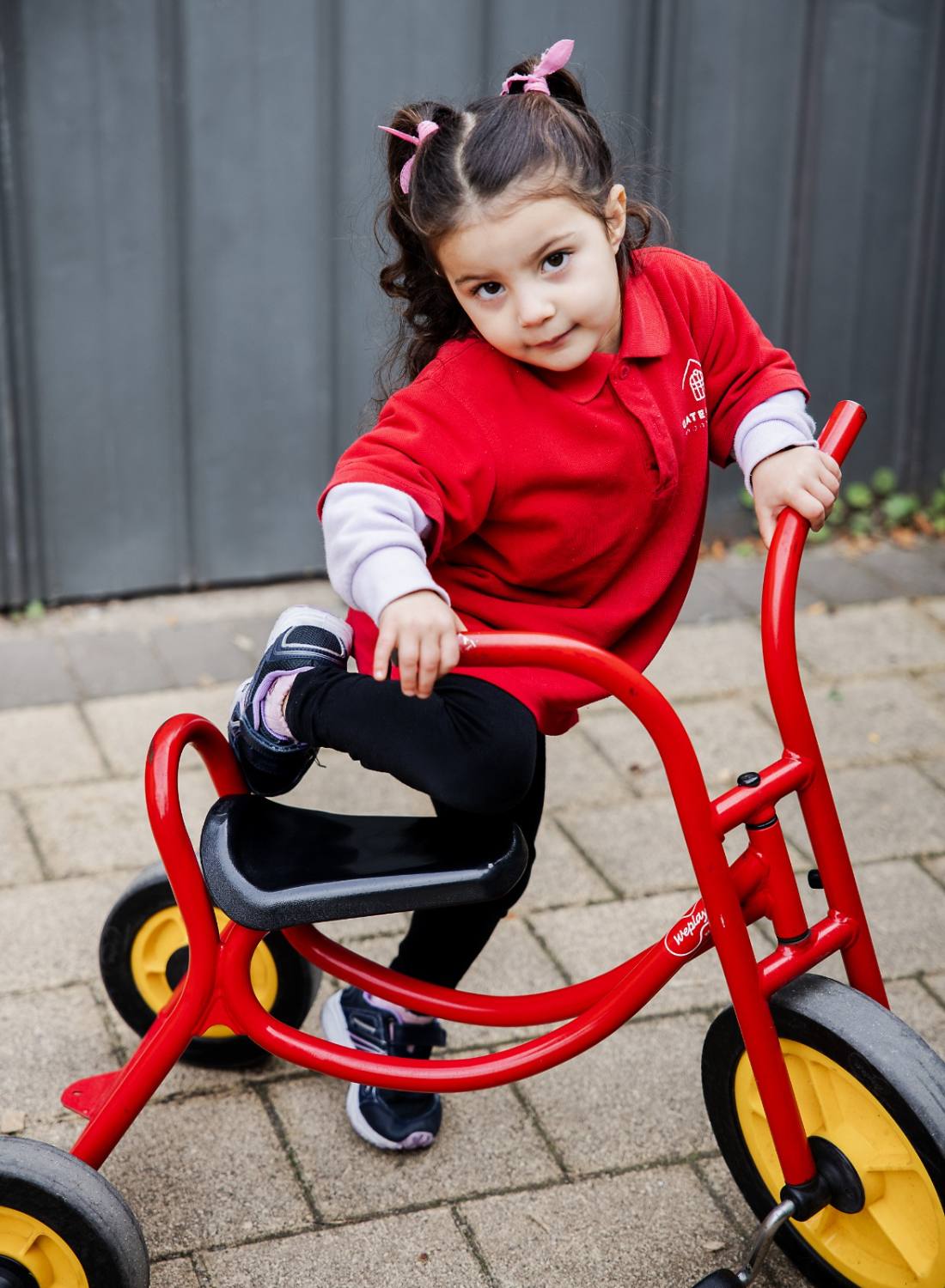 Child riding a tricycle outdoors